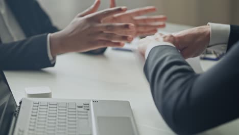 disappointed businessman arguing with partner and tearing down paper contract