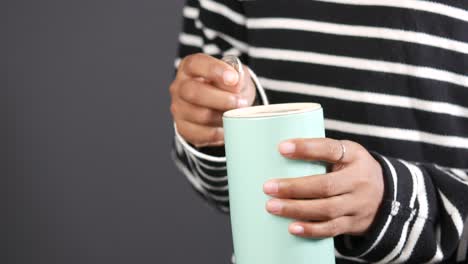 child boy hand hold a saving coins jar