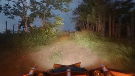 fpv view of a can-am driving at high speed at night in a rural zone in a mountain of the dominican republic