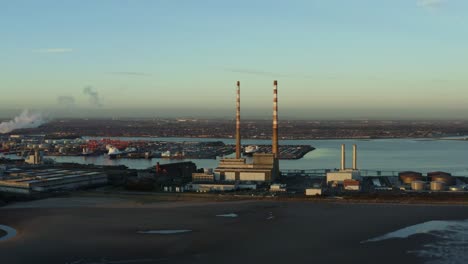 aerial tracking shot of dublin port at sunset