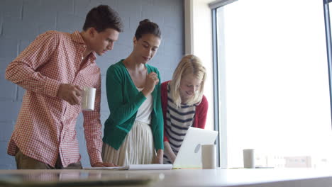 casual colleagues using a laptop