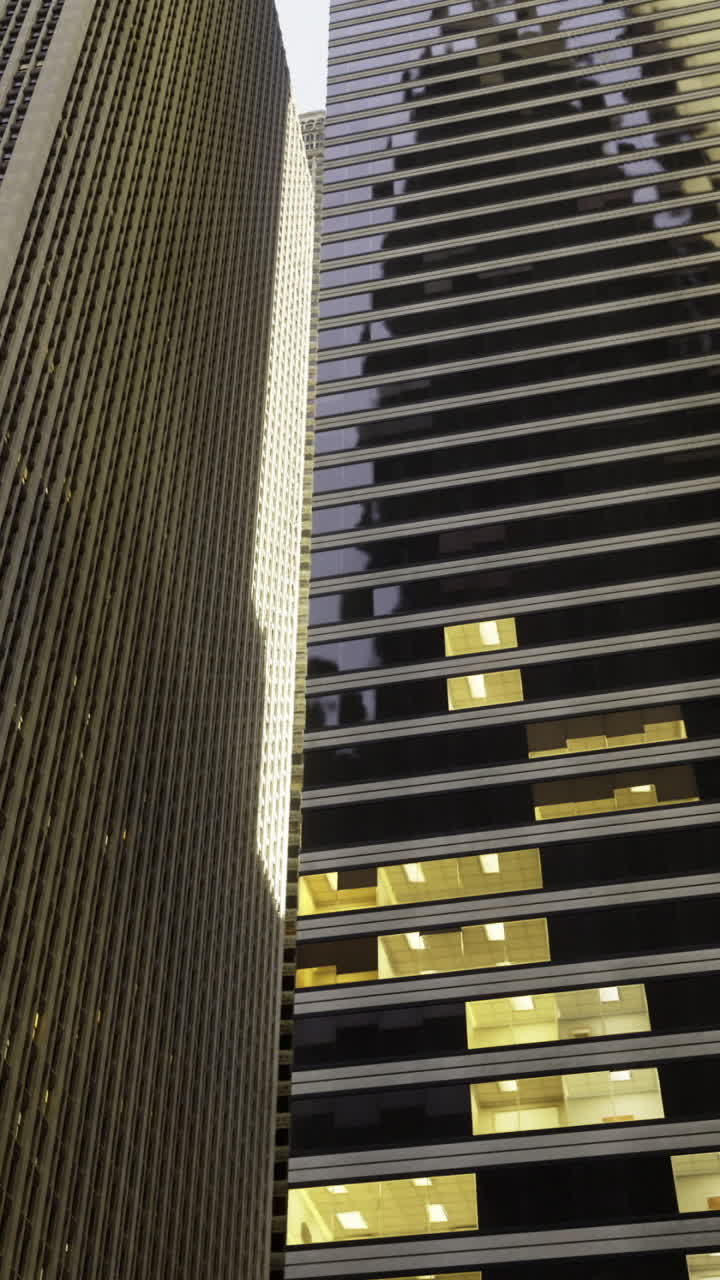Skyscrapers illuminated at dusk reflecting urban architecture