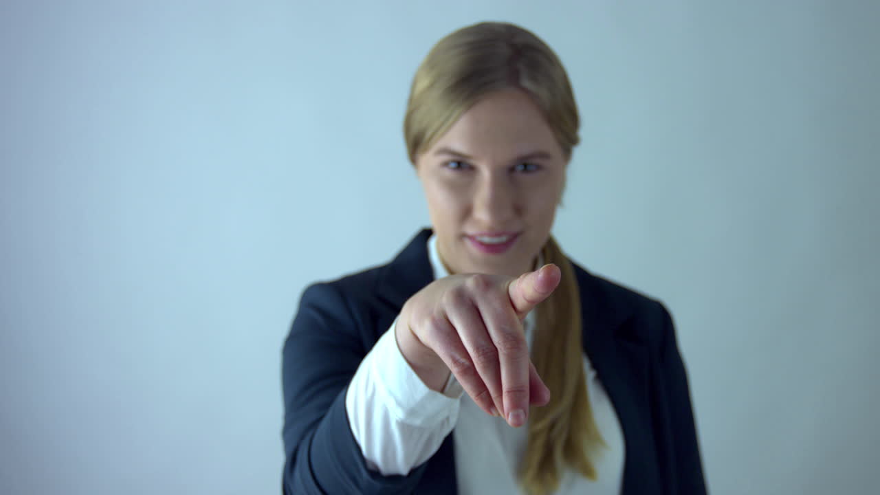 Smiling business woman presses virtual button with finger