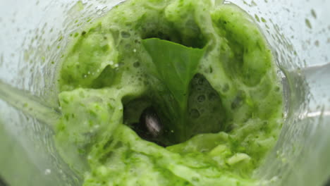 top view vegan cocktail swirling in blender close up. vegetables blending mixer.