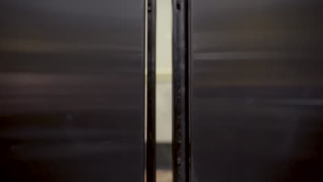 elevator doors opening to reveal marble wall