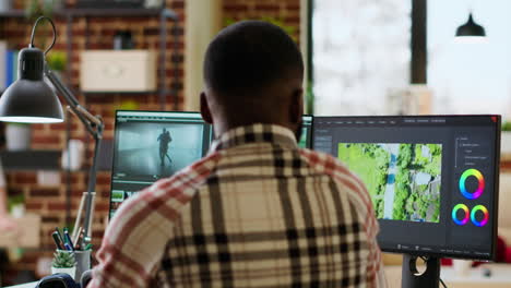 male video creator edits a multimedia project at a modern office