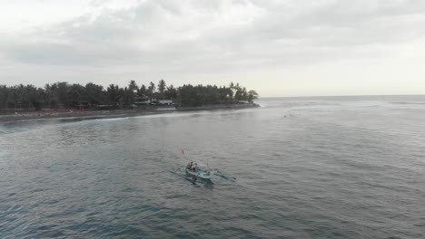 Orbit-shot-of-Indonesian-fishing-boat-at-Bali-Indonesia,-aerial