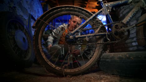 a kid admires the forgotten vintage bicycle. old-fashioned cycle. nostalgia.