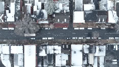 top down aerial of city street with snow flurries