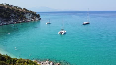 catamaran and sailboats anchored near navagio beach - shipwreck beach in zakynthos, ionian islands, greece