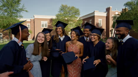 group of happy graduates celebrating by throwing caps in the air