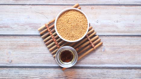 Mustard-seeds-and-oil-in-container-on-table