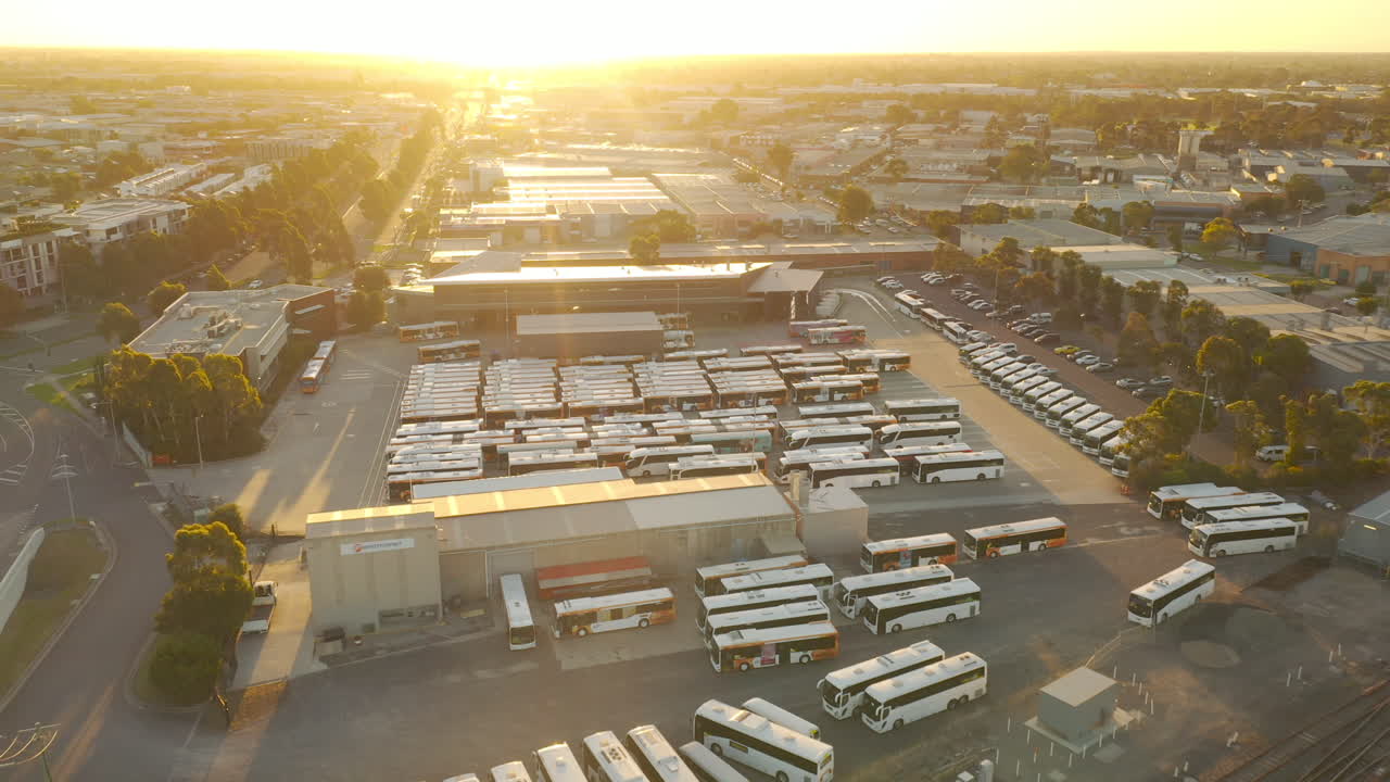 Tracking coach into bus depot while following passing passenger train.