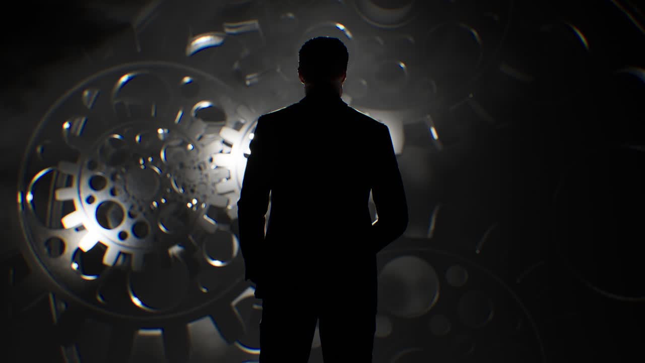 기어와 이 회전하는 앞에 서 있는 사업가