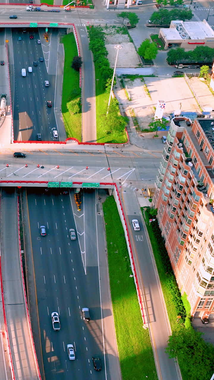 Picturesque green street with cars. Aerial view of the 90 Freeway in Chicago. Vertical video