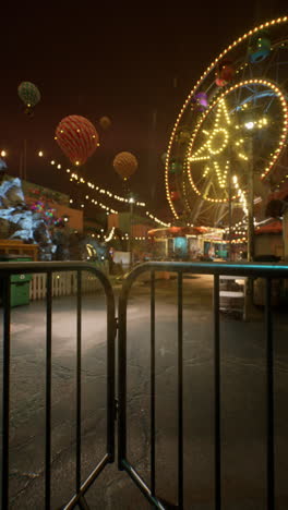 empty ferris wheel and hot air balloons at night