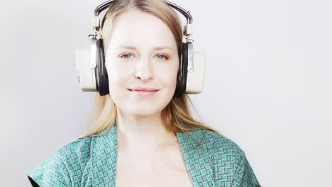 cool female dancer with changing retro headphones to listen to music