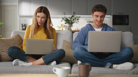 freelancers couple working laptops at domestic interior. family remote workplace