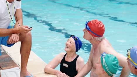 swim coach interacting with seniors