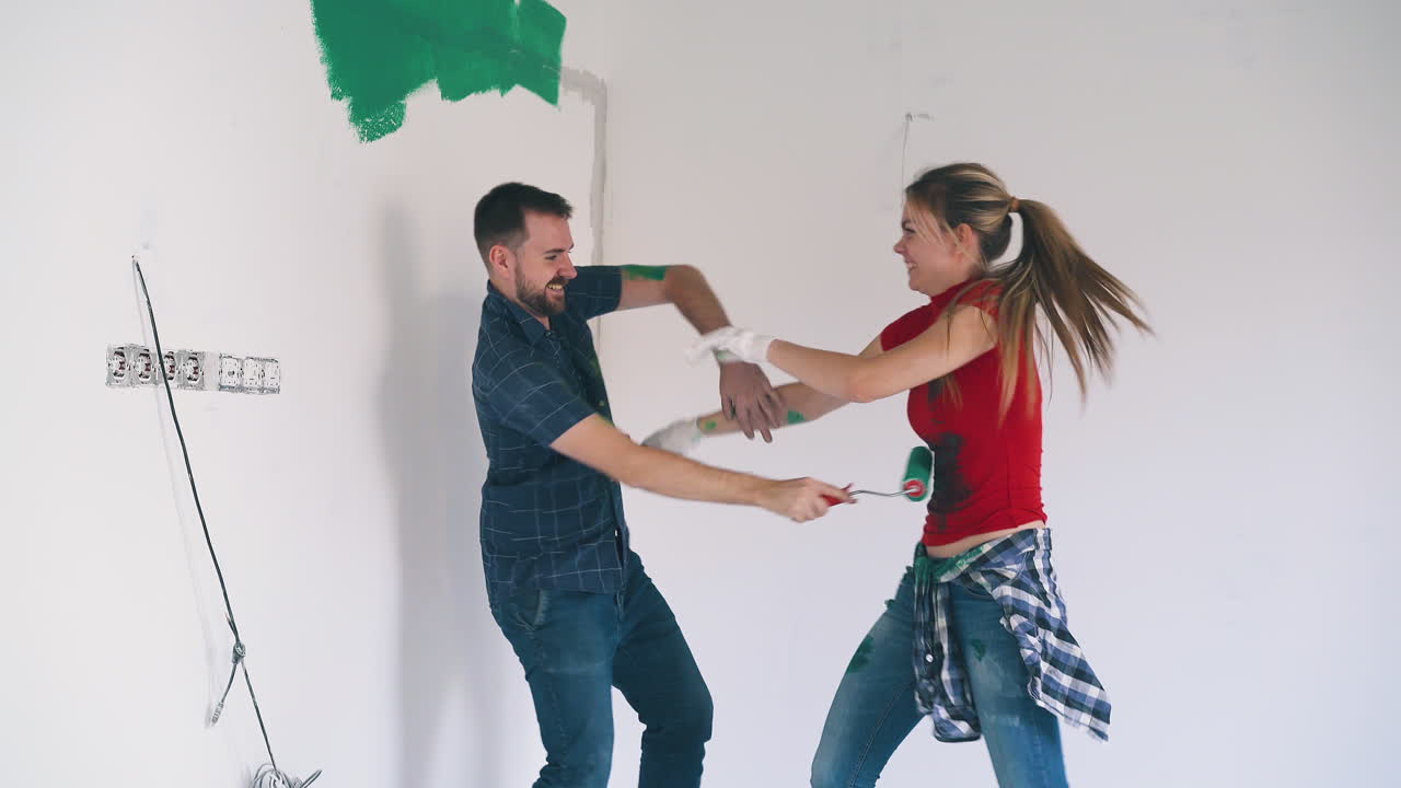 couple has fun painting each other at construction in room
