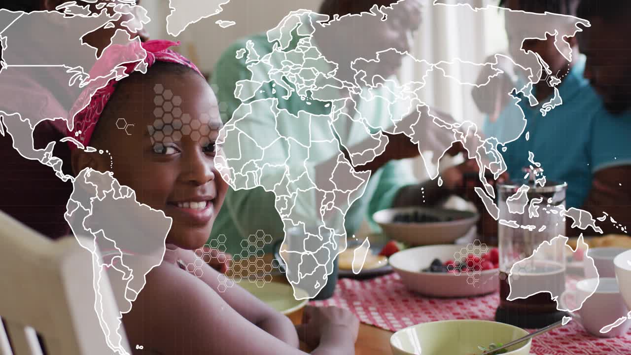 Girl smiling at camera while family eating, map overlay fading across frame, showing global tech