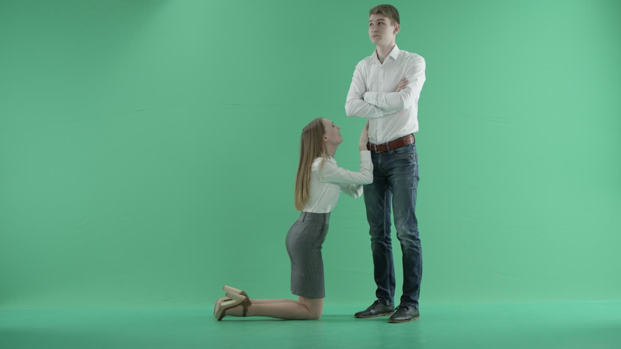 Businesswoman apologizing businessman.Girlfriend trying to convince boyfriend. Woman asking for forgiveness.Green screen