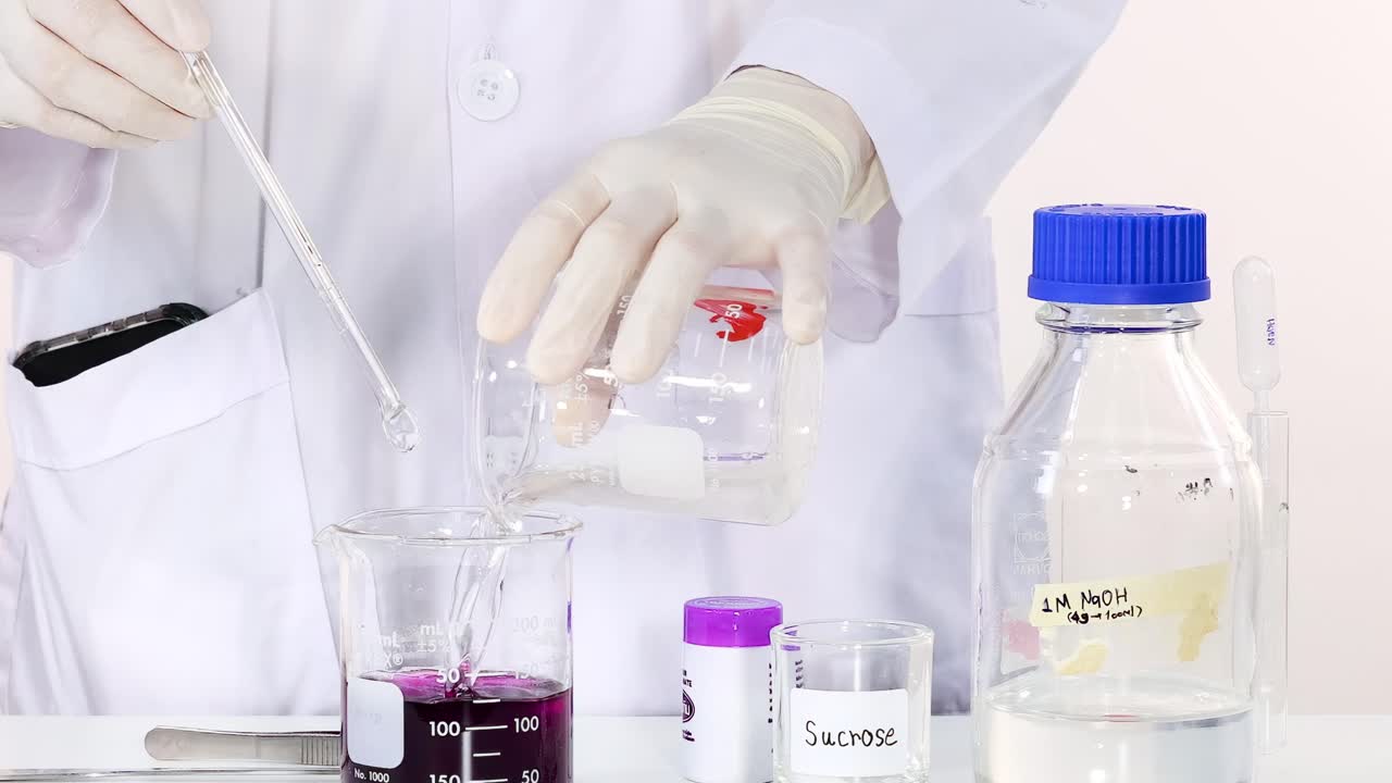 Observe the color change in a beaker as a sucrose solution is mixed.