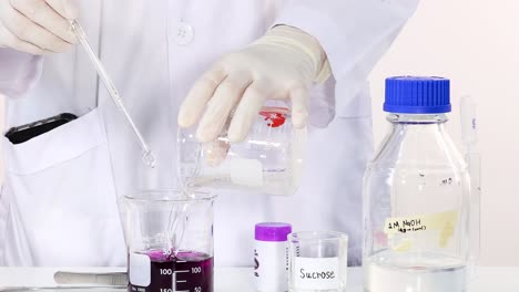 observe the color change in a beaker as a sucrose solution is mixed.