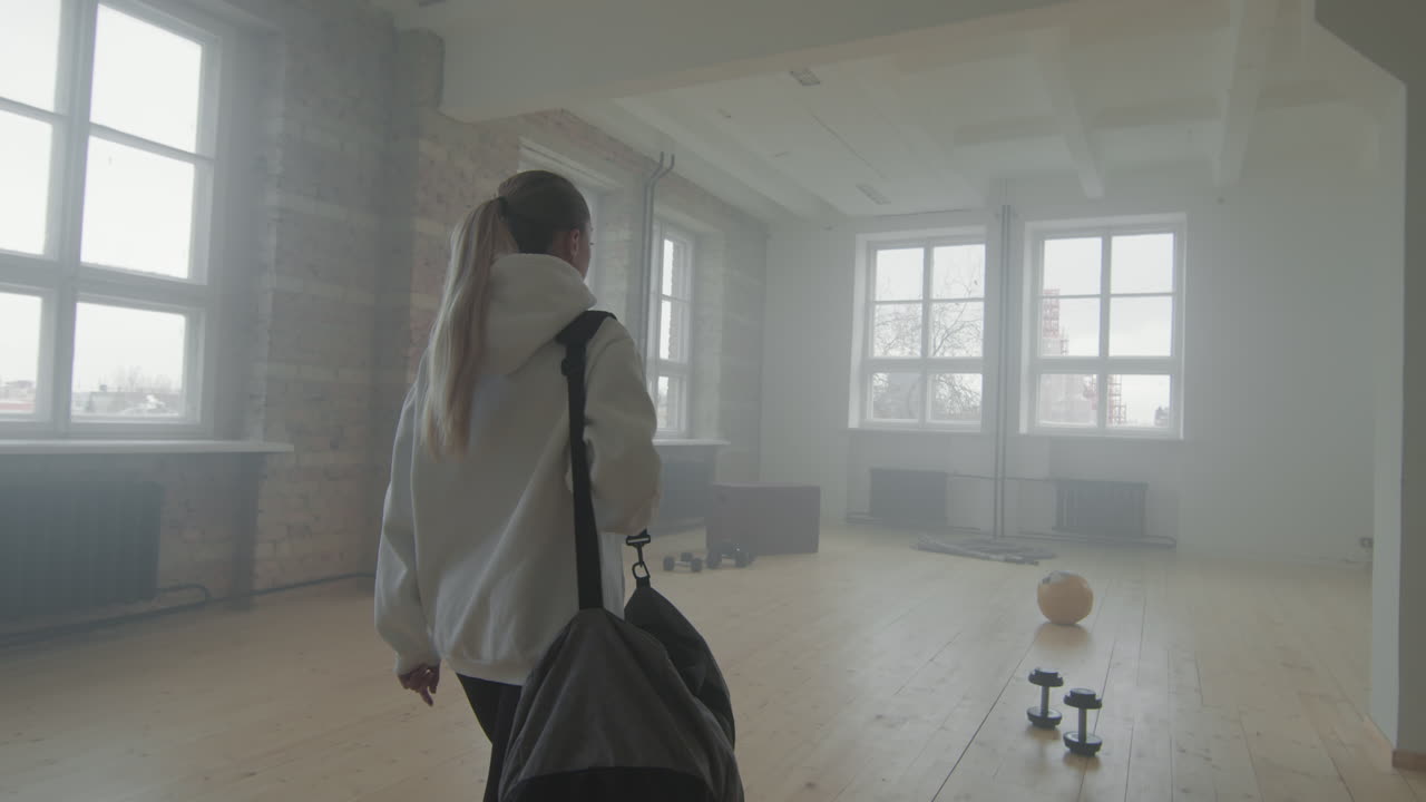 Woman Arriving At Loft Style Gym