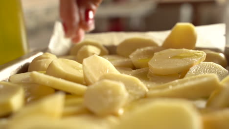 Sliding-shot-pouring-salt-into-cut-potatoes-in-slow-motion