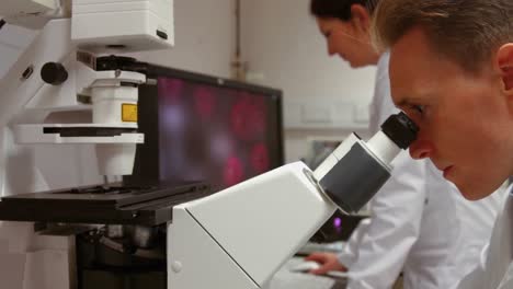 Scientist-looking-through-a-microscope