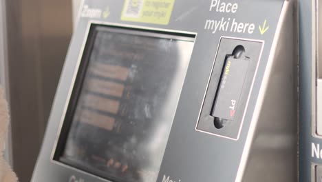 person interacting with melbourne tram ticket machine