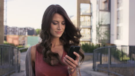 mujer hermosa usando una aplicación de tecnología de teléfono inteligente caminando por la ciudad