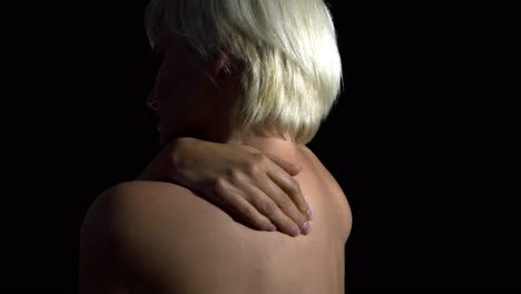 pain in shoulder concept. woman massaging her back