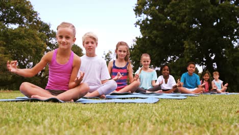 group of children performing yoga