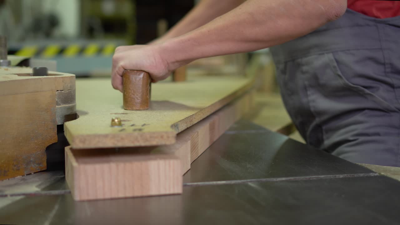 Close-up of a person operating a woodworking machine