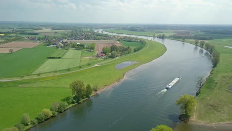 aerial drone view of the river and container shipping ship passing by