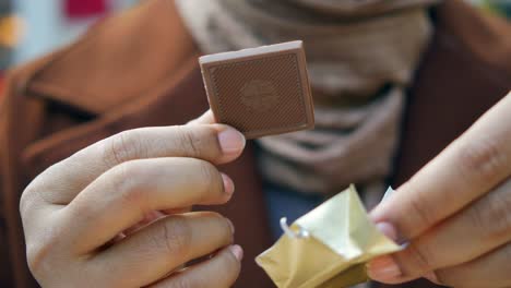 woman unwrapping a chocolate bar