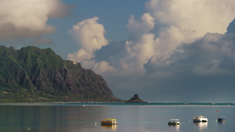 kualoa ranch and china mans hat timelapse with boats in foreground and stormy clounds