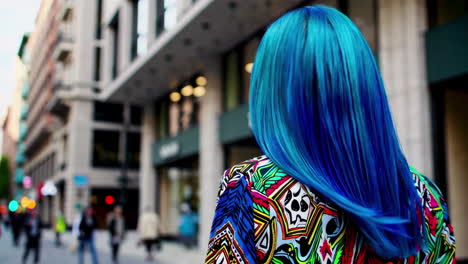 woman with vibrant blue hair in a city street