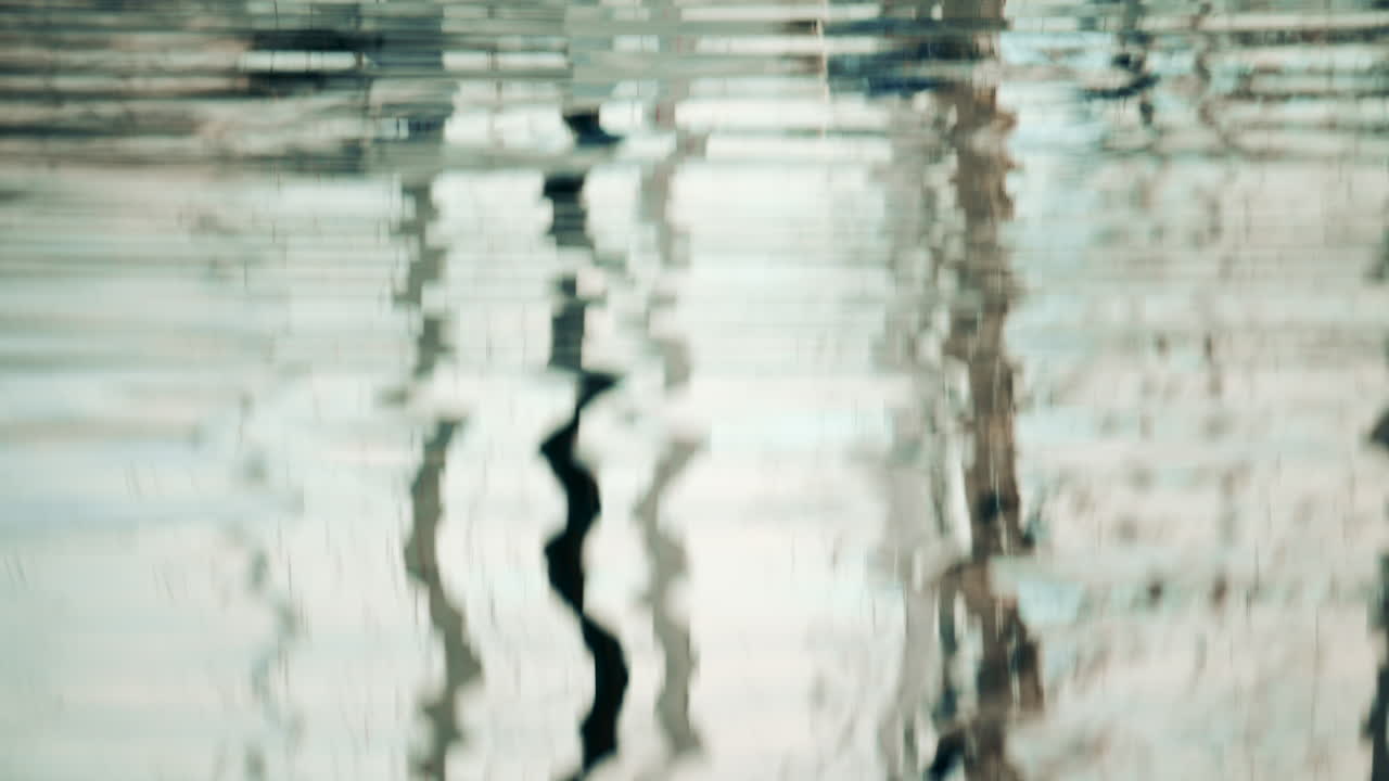 Reflections of boats and masts rippling on the water