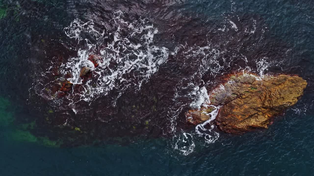 Aerial view of rocky formations and waves in Bulgaria's coastline