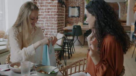 two women celebrating at cafe
