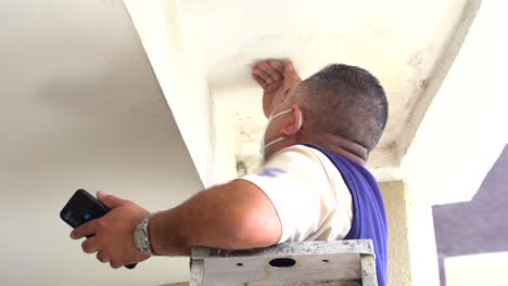 latin man in ladder