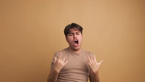 successful man shouting joyfully in beige studio