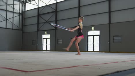 teenage female gymnast performing at sports hall