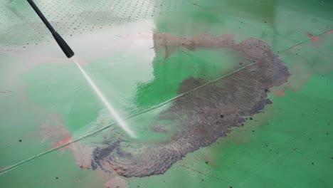 slow motion video 4k closeup water that washes high-pressure ship deck floors from a pressure washer