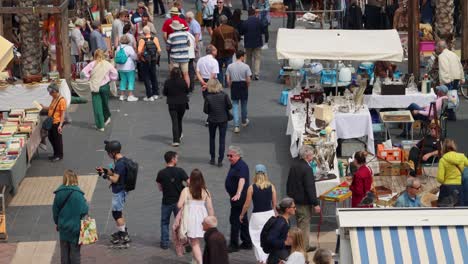 crowded antique or flea market on famous street cours saleya in nice, france