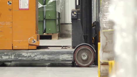 a forklift pulls a pallet of boxes from a rack