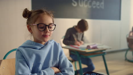 smart girl raising hand at lesson. smiling student answering question